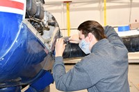 student working on airplane
