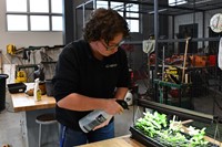 student watering plants