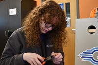 Student cutting cables